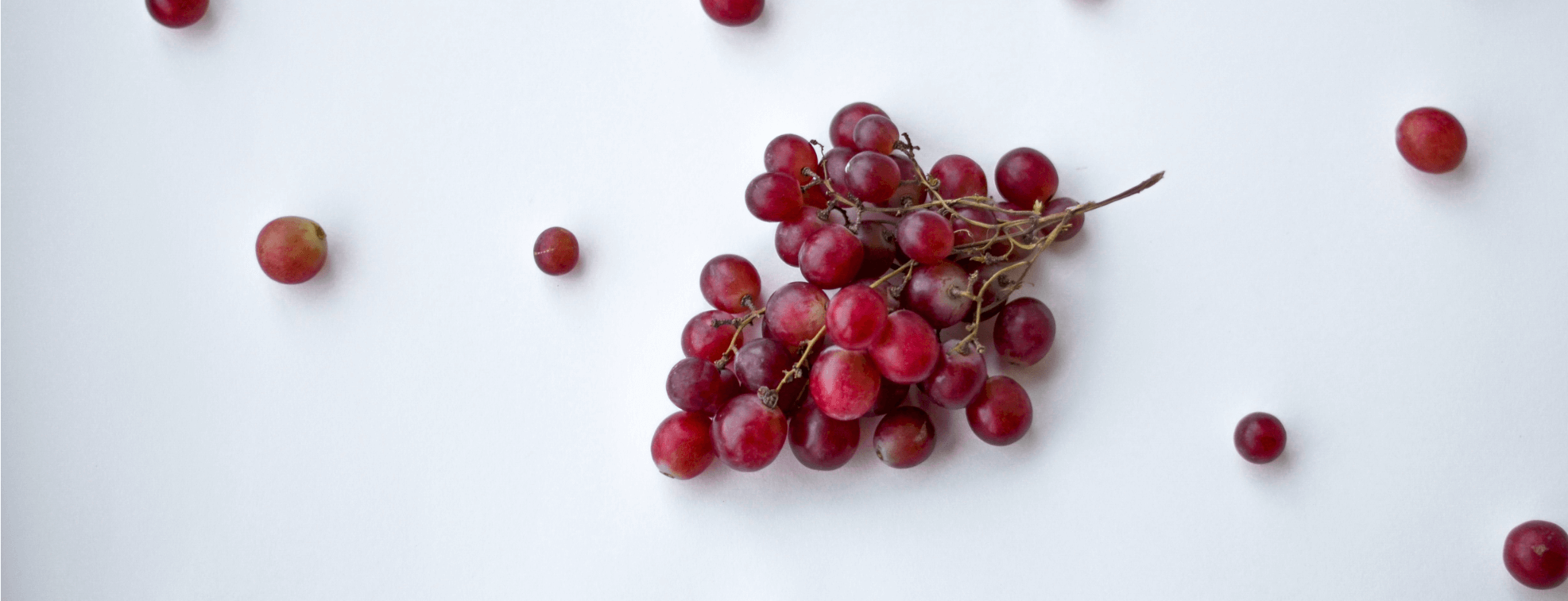 Red grapes on a white table