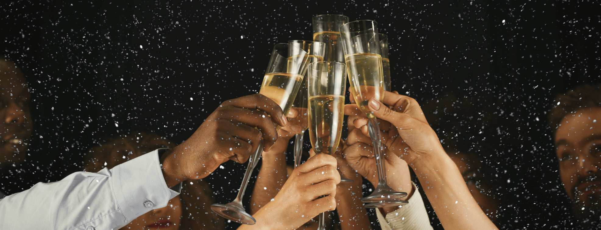 People stretching their hands to celebrate the coming of the New Year with champaign