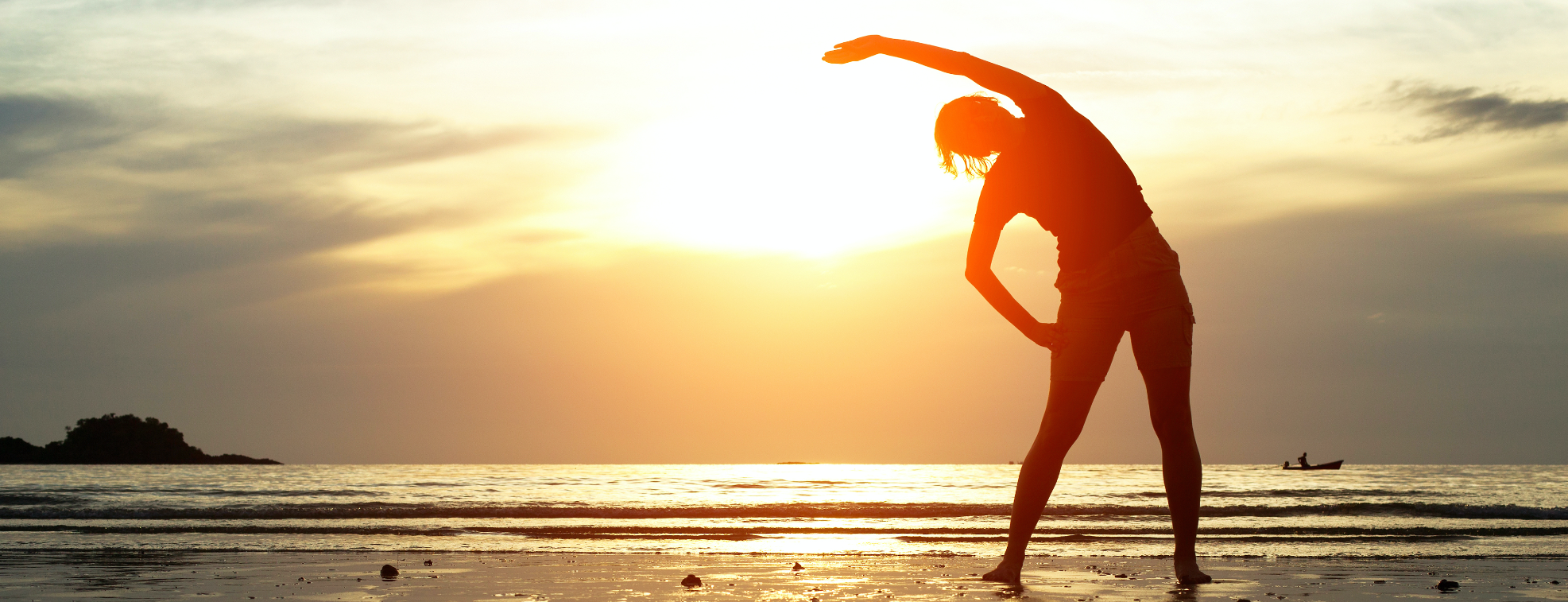A woman exercising while looking at a sunset